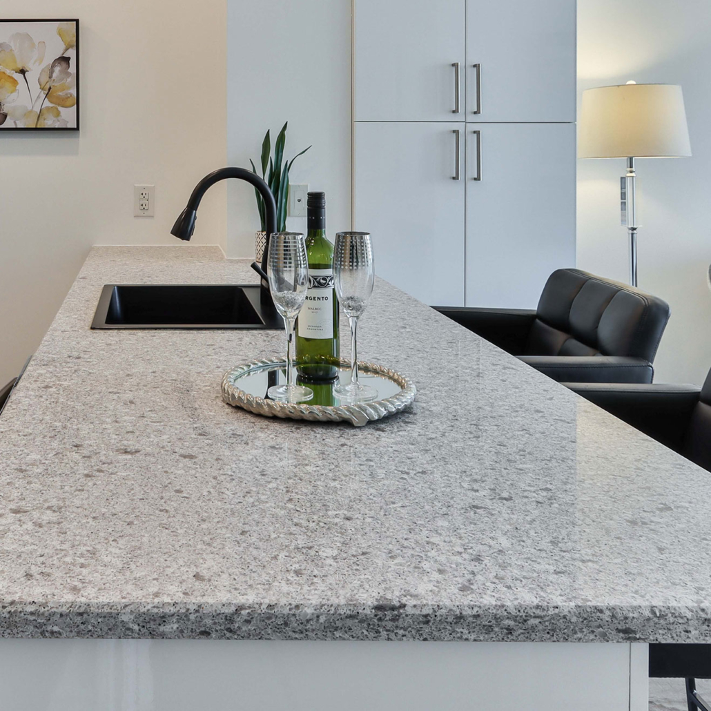 Kitchen with grey granite countertops.